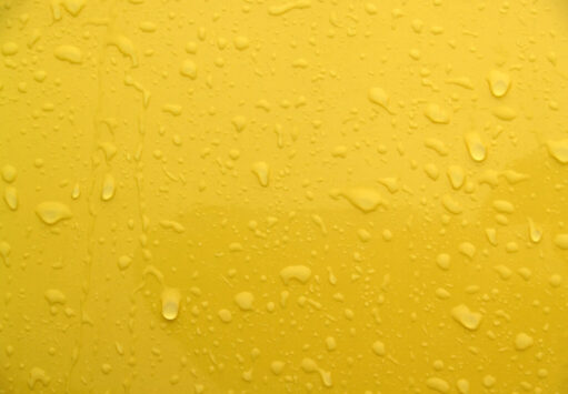 backgrounds: textural: wet yellow painted metal